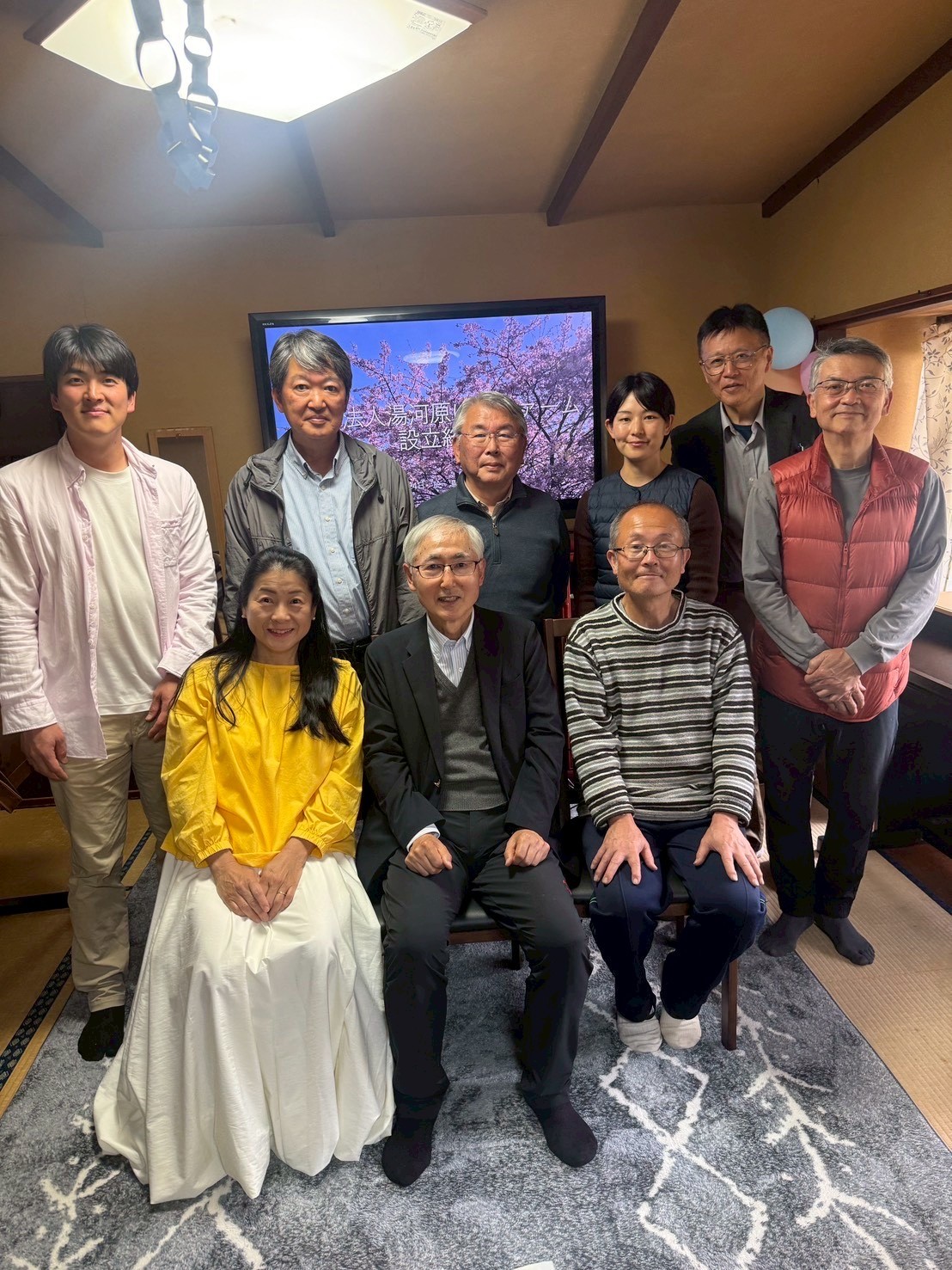 Nine Yume Farm members gathered indoors for a group photograph